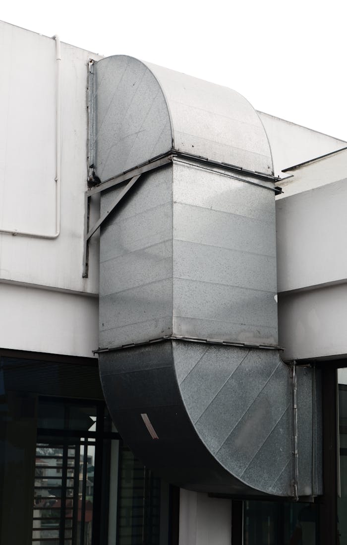services-01 Close-up of a contemporary ventilation duct exterior in a city setting.
