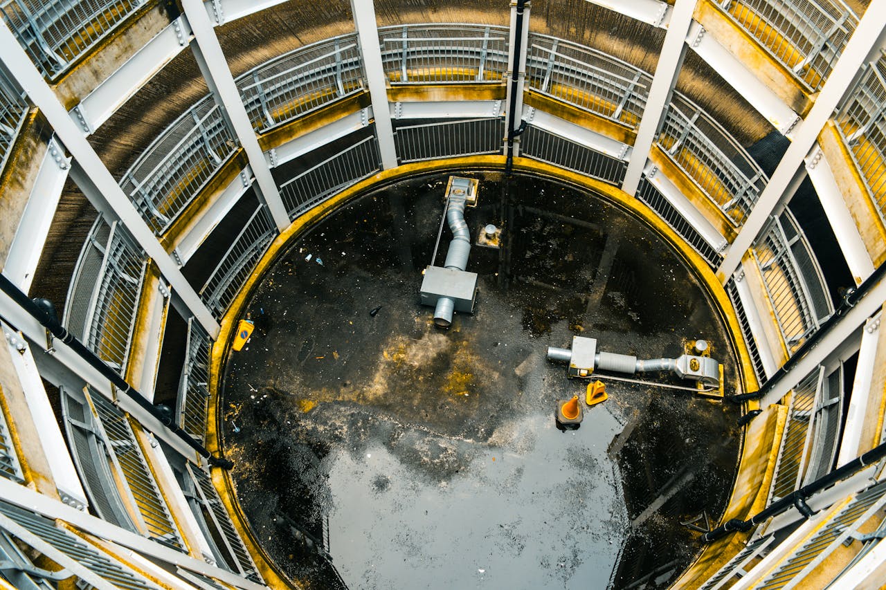 about-03 Aerial view of an industrial structure with metal railings and ventilation pipes.